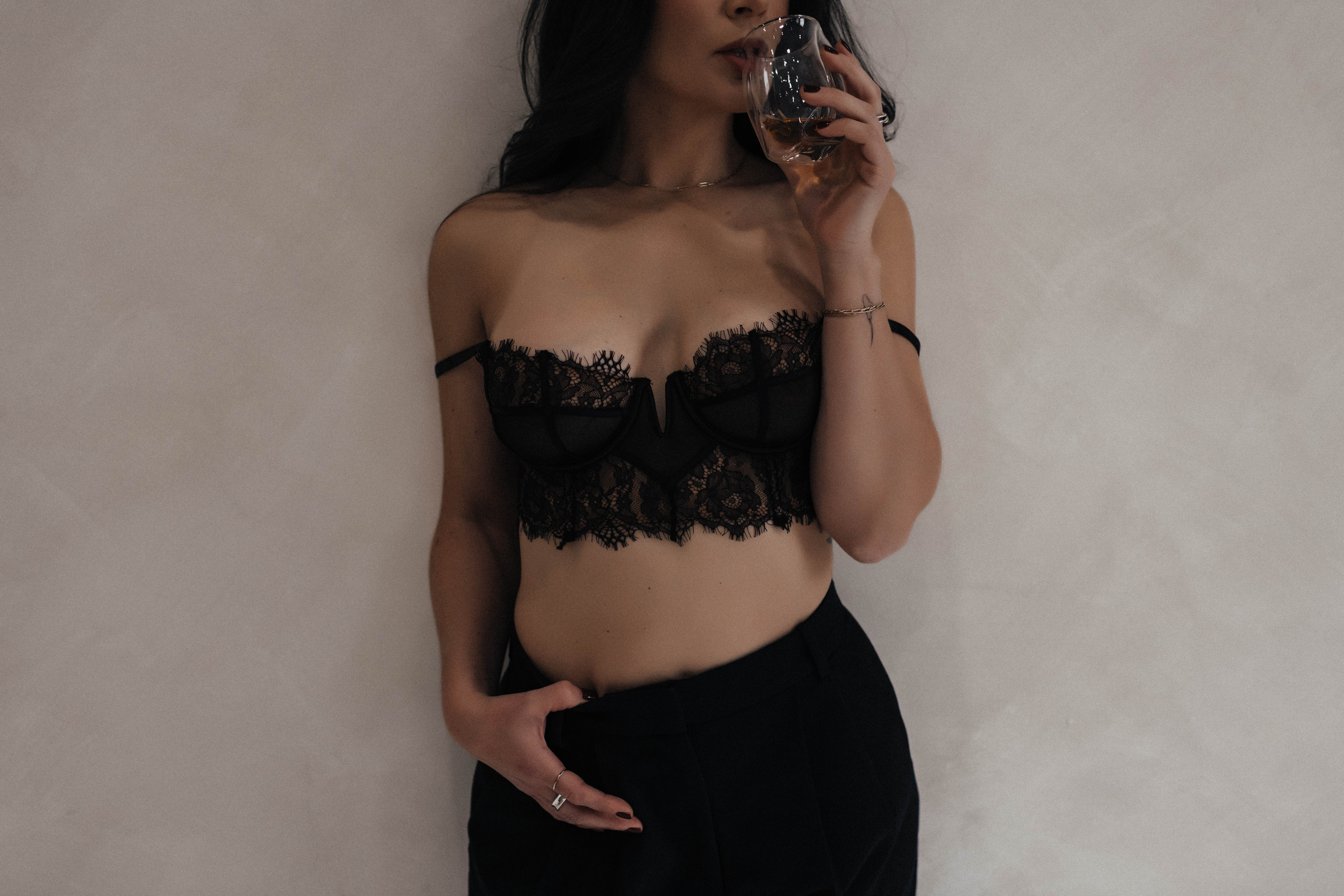 Woman honoring herself through empowering boudoir session in black lace lingerie