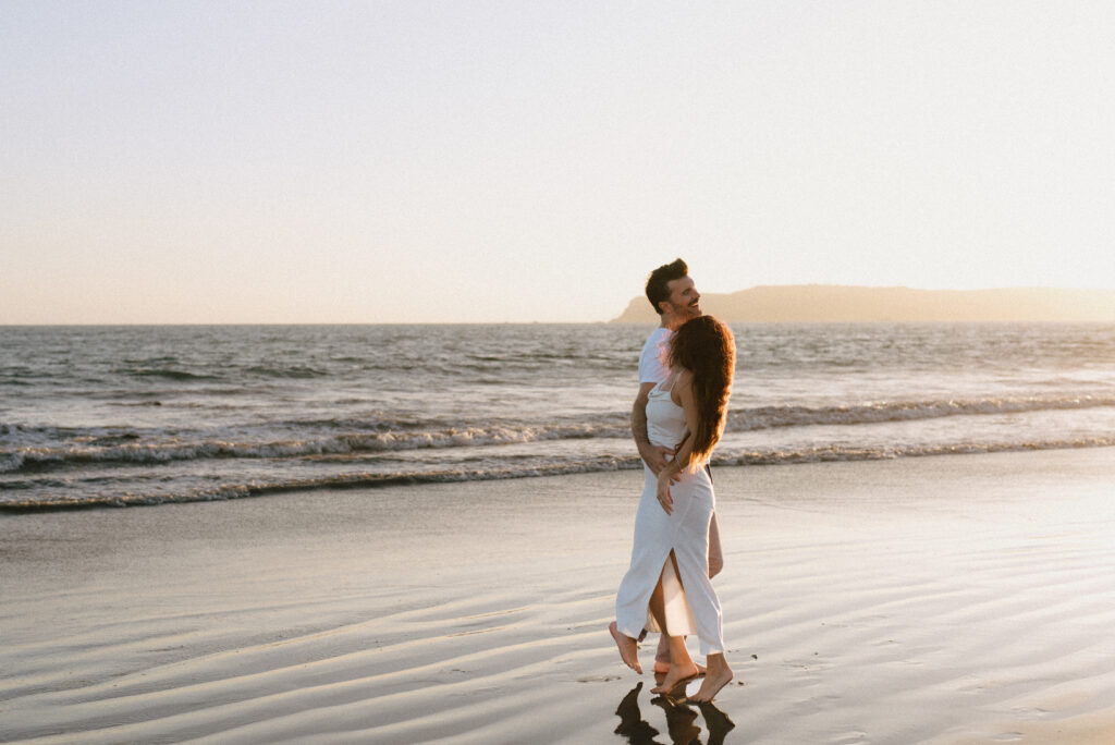 PNW beach engagement session, playful couple photos at sunset, outdoor engagement portraits Seattle, warm and emotional photography style, Seattle wedding and engagement photographer, documentary-style couples photography