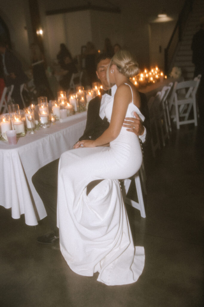 Bride seated quietly at reception table, emotional calm moment wedding reception Seattle, candlelit wedding portrait Seattle