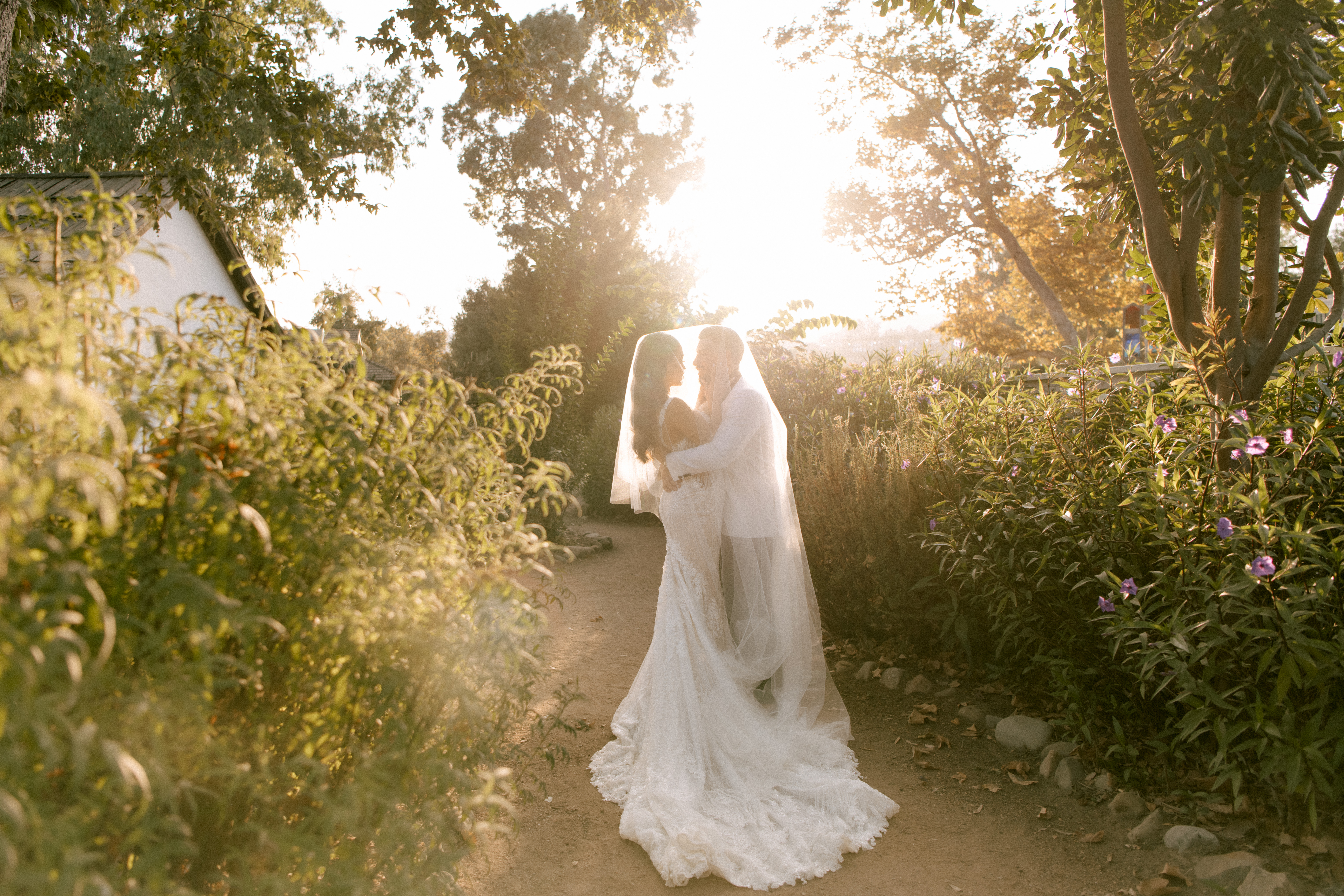 Bride walking through golden sunlight during outdoor wedding, captured by Seattle wedding photographer Rachael Marie