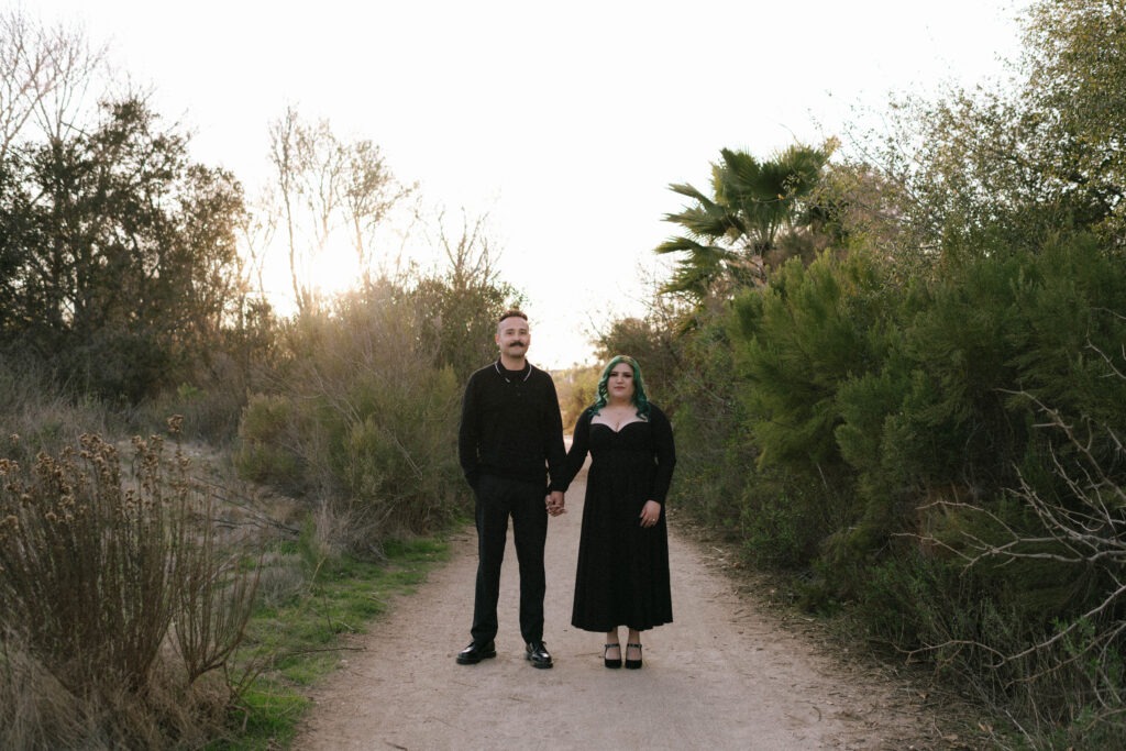 Karina and Max standing together on a trail during their Rancho Peñasquitos engagement session in San Diego